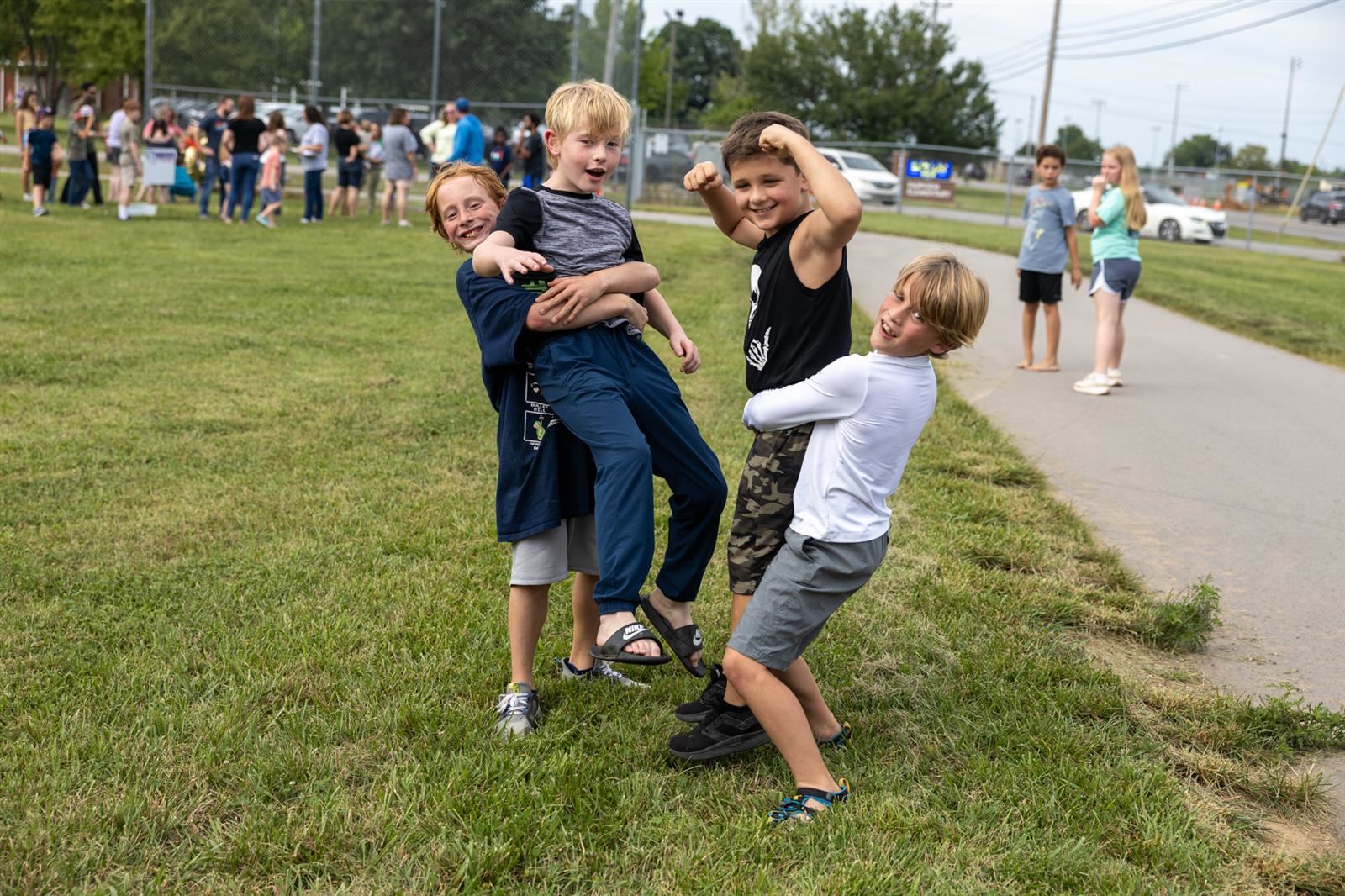 boys being silly in the grass